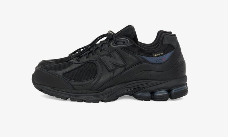 side view of New Balance black sneaker