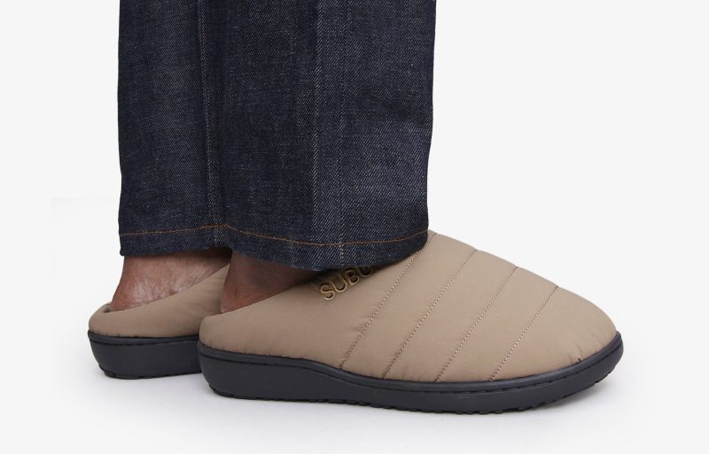 man wearing khaki quilted clogs