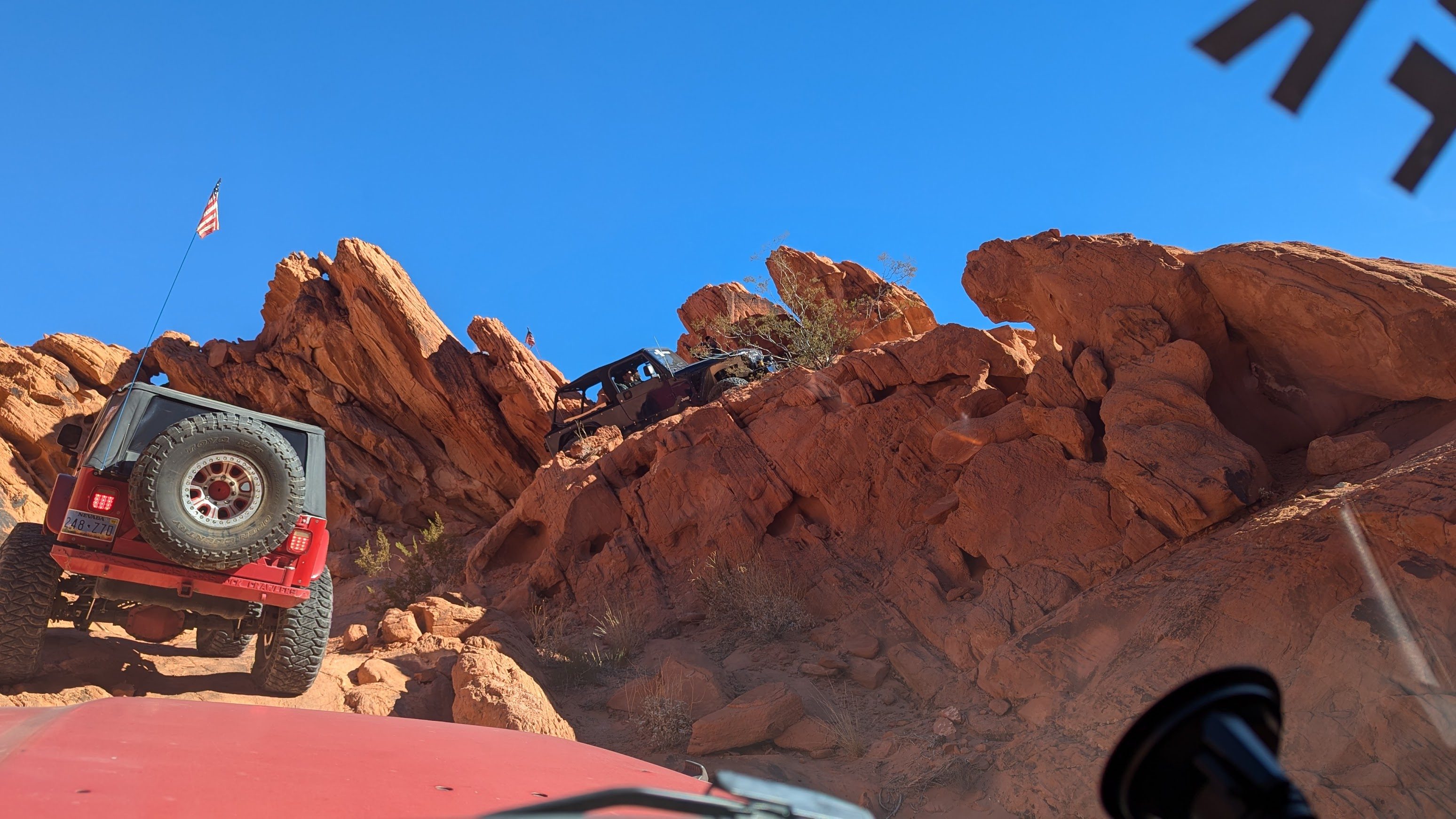 Two Jeeps crawling up a trail