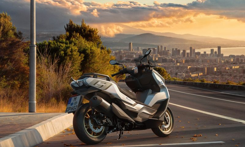 Parked 2025 BMW C 400 overlooking a city right rear three-quarter view.