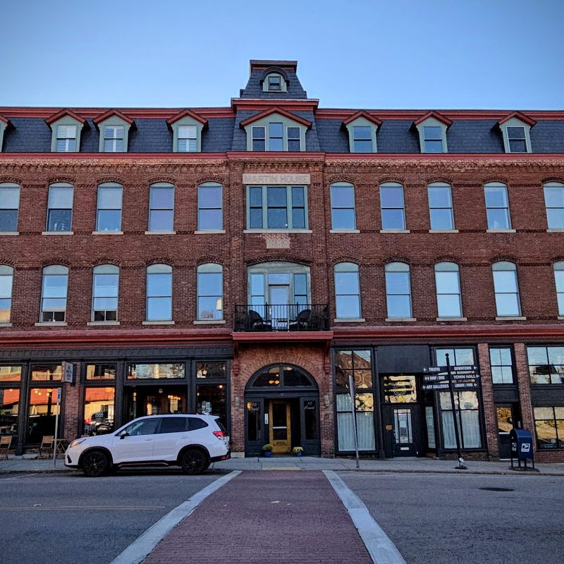 A historic building hosting local businesses in downtown Westerly, RI