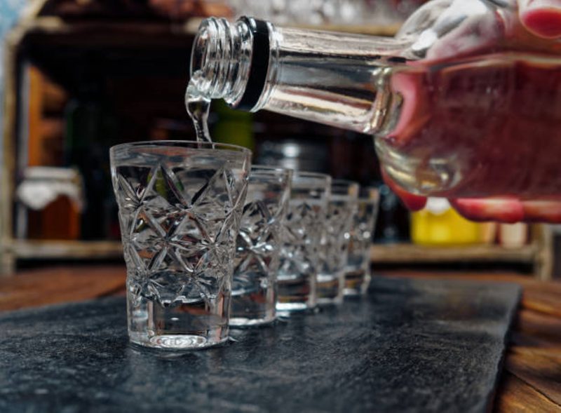 Pouring vodka into glasses