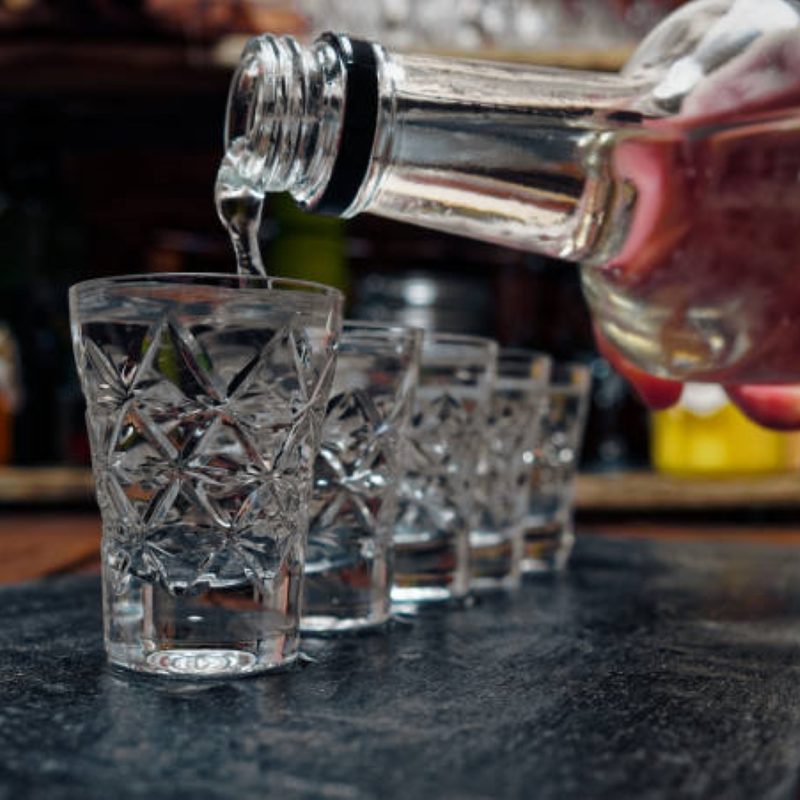 Pouring vodka into glasses