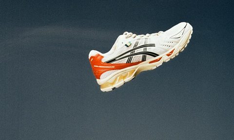 white and red sneaker in mid air