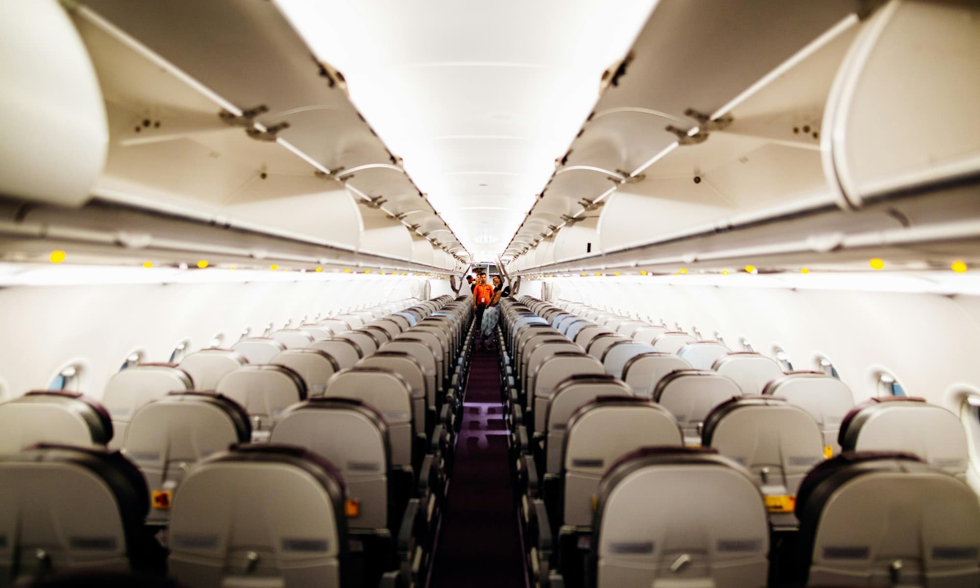 The inside of an airplane with empty seats