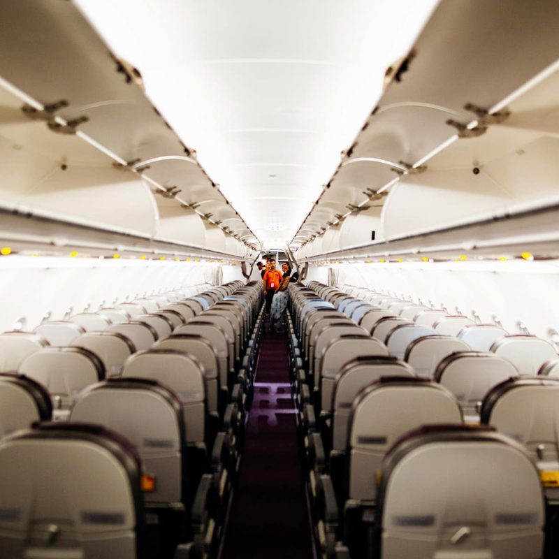 the inside of an airplane with empty seats