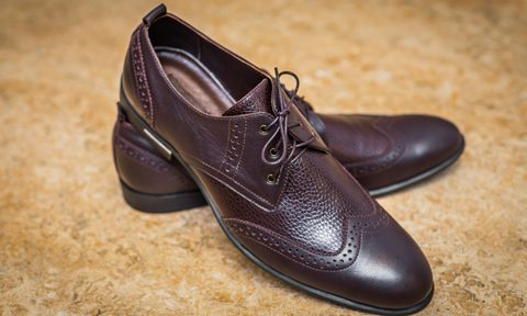 brown leather wingtip shoes on top of each other