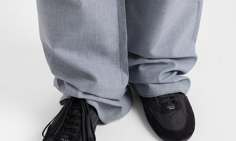 model wearing gray pants and black sneakers