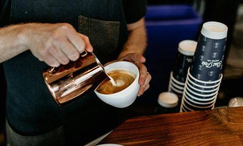 Pouring cream in coffee