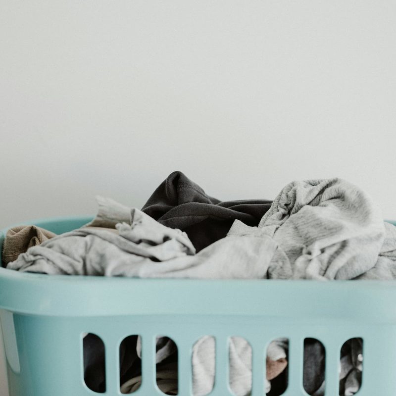Dirty laundry in a blue basket