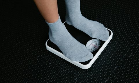 Standing on a scale weighing body weight