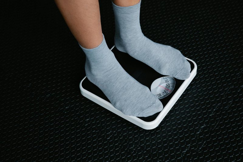 standing on scale weighing scale body weight weight loss fee