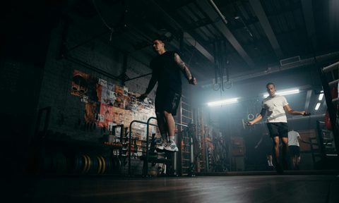 man jumping rope in gym jump rope aerobic cardio exercise