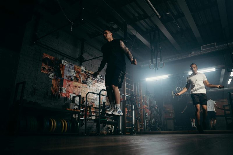 man jumping rope in gym jump rope aerobic cardio exercise