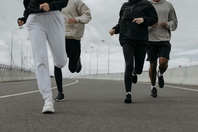 people group running together outside on road