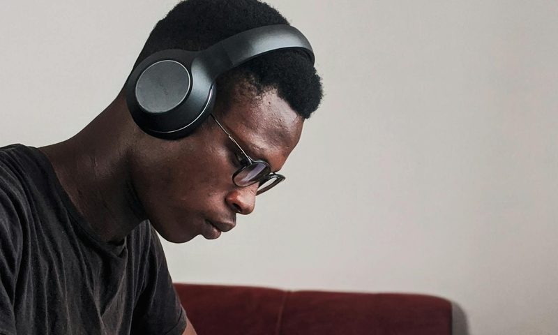 man headphones thinking smart reading book writing