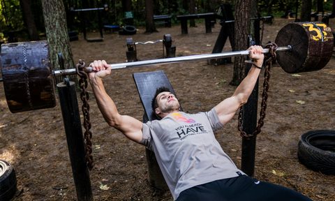 Man bench pressing outside