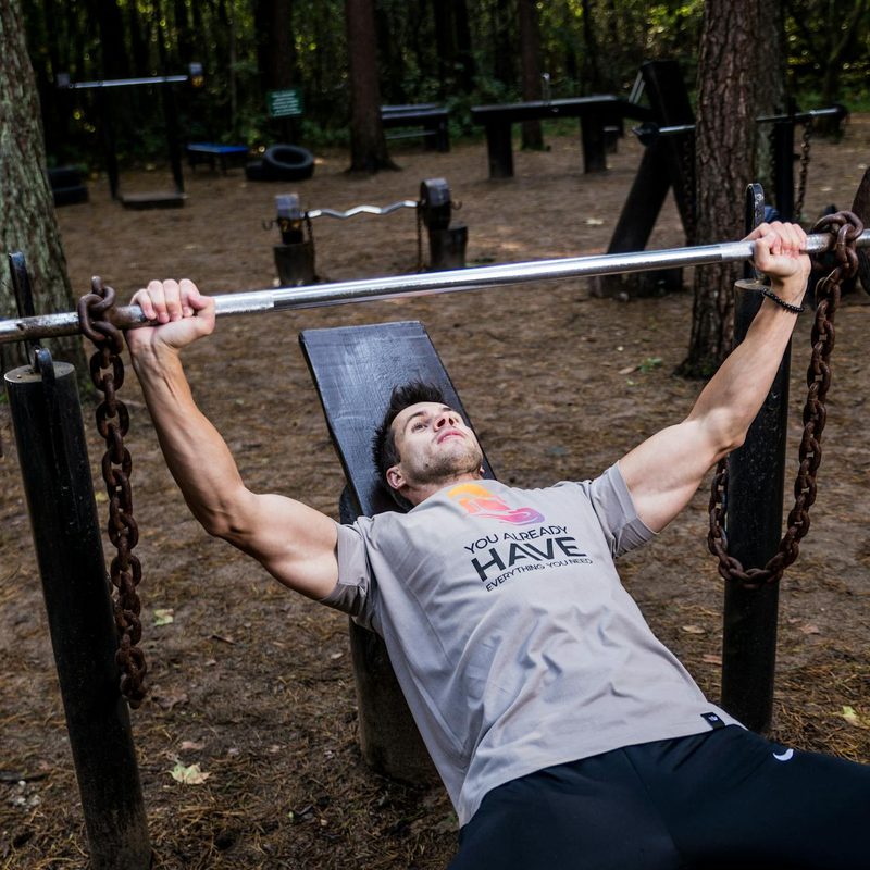 Man bench pressing outside