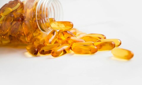 Fish oil supplement in bottle on table