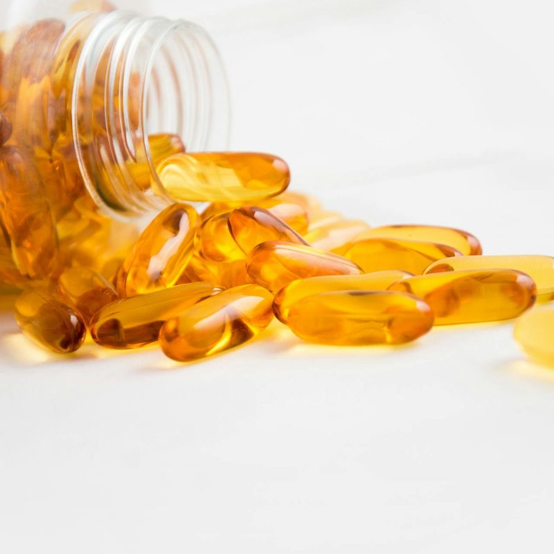 Fish oil supplement in bottle on table