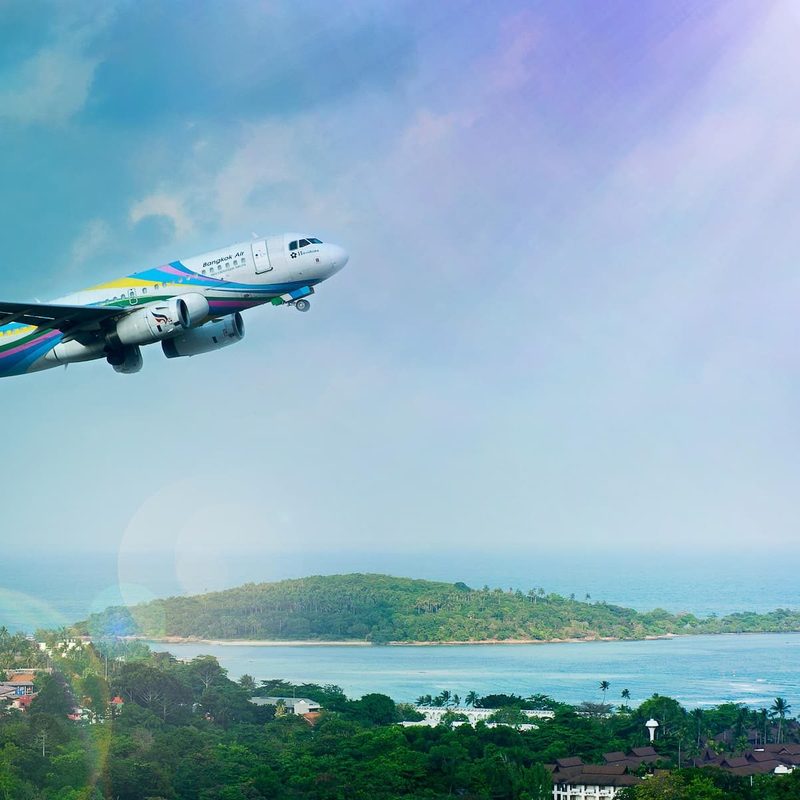 Plane taking off with ocean in the background