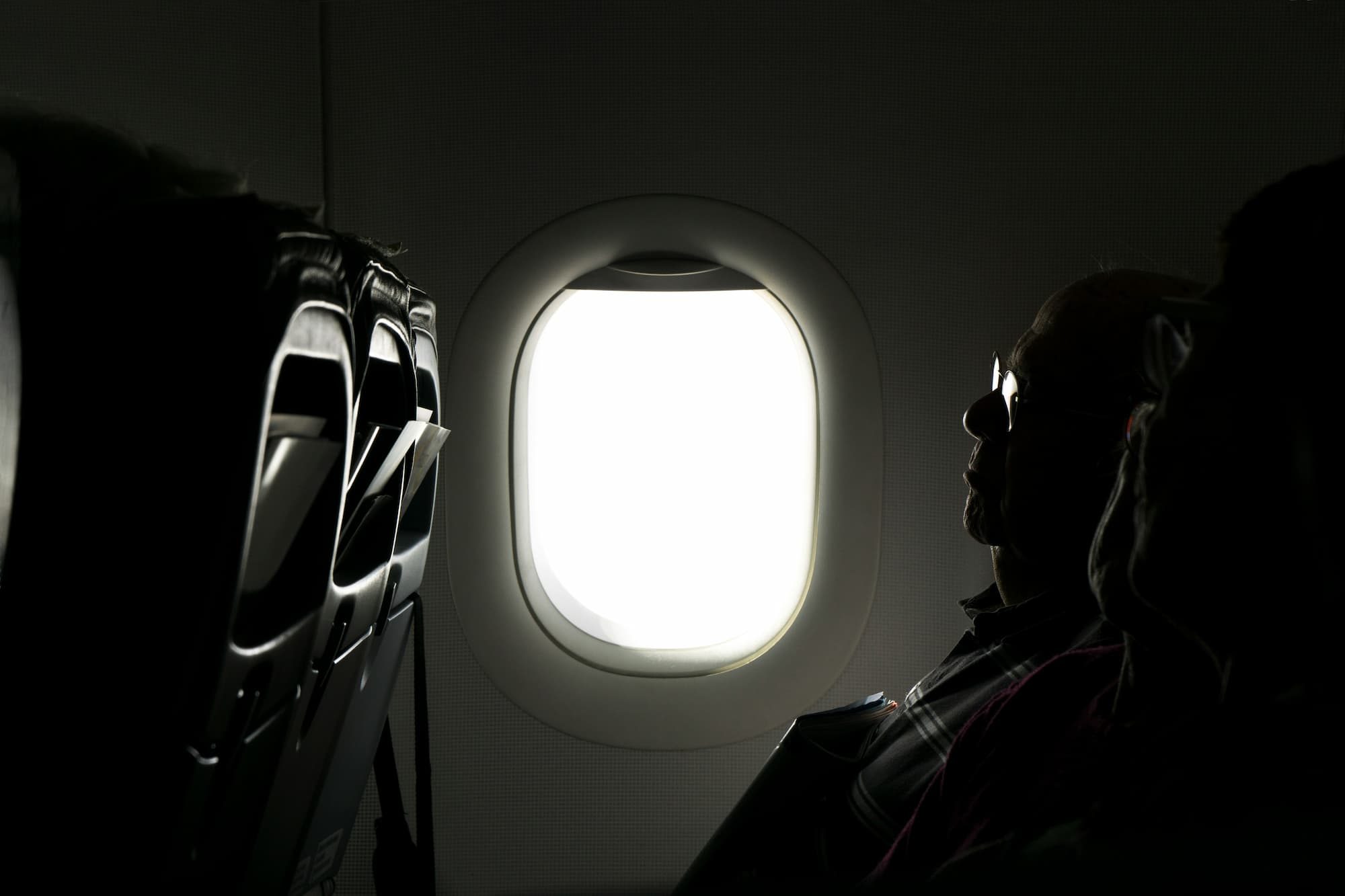 A person sitting on an airplane sleeping