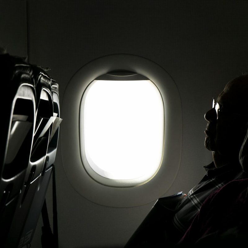 A person sitting on an airplane sleeping