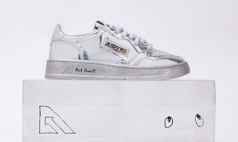 silver sneaker sitting on top of transparent shoe box