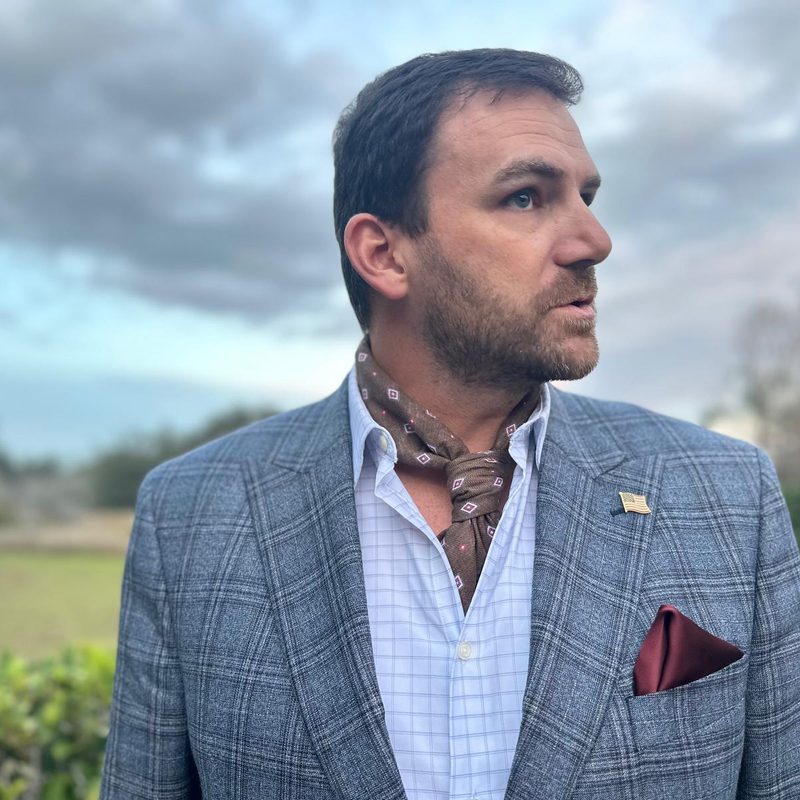 Man in neckerchief and suit
