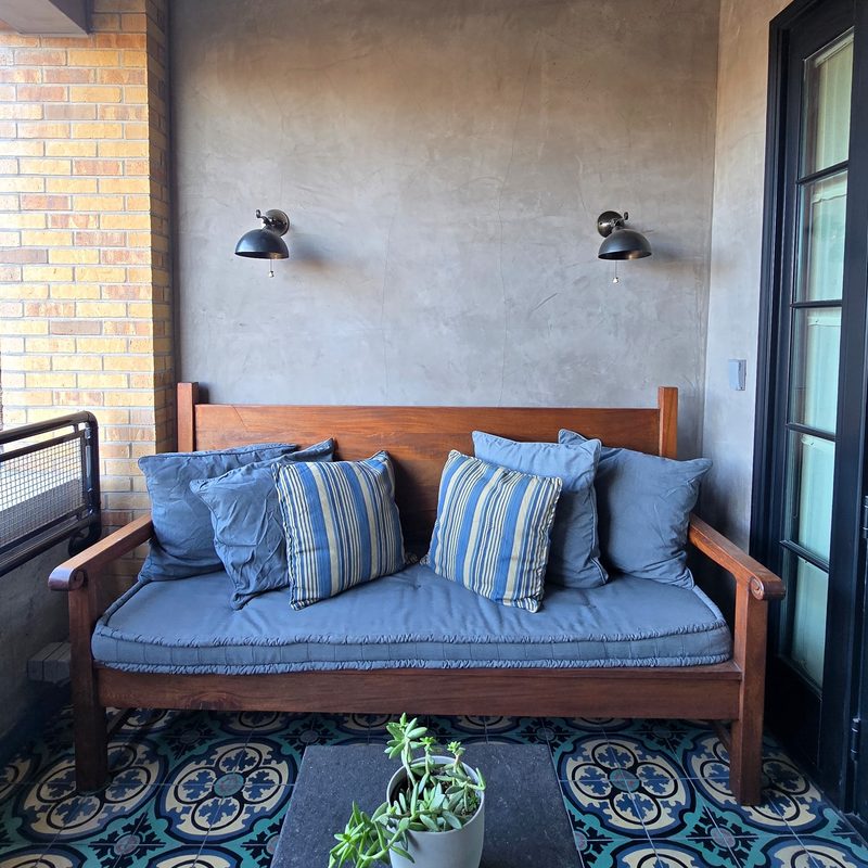 Patio outside of a room with a couch at Hotel Emma
