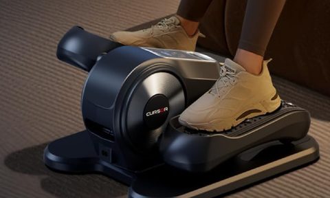 A person using the Cursor Under Desk Elliptical Machine.