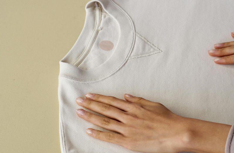 Hands flattening a shirt