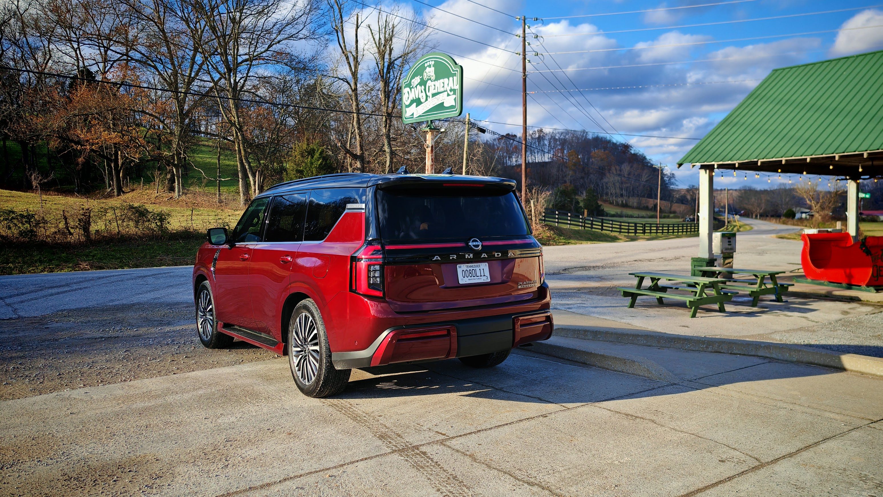 Rear 3/4 view of a 2025 Nissan Armada parked at a convenience store