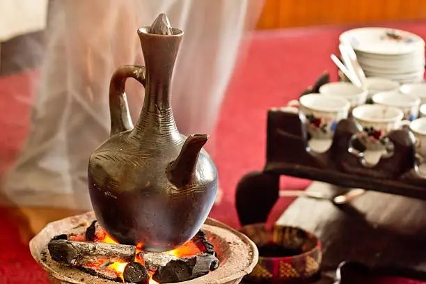 A jebena roasts over a fire