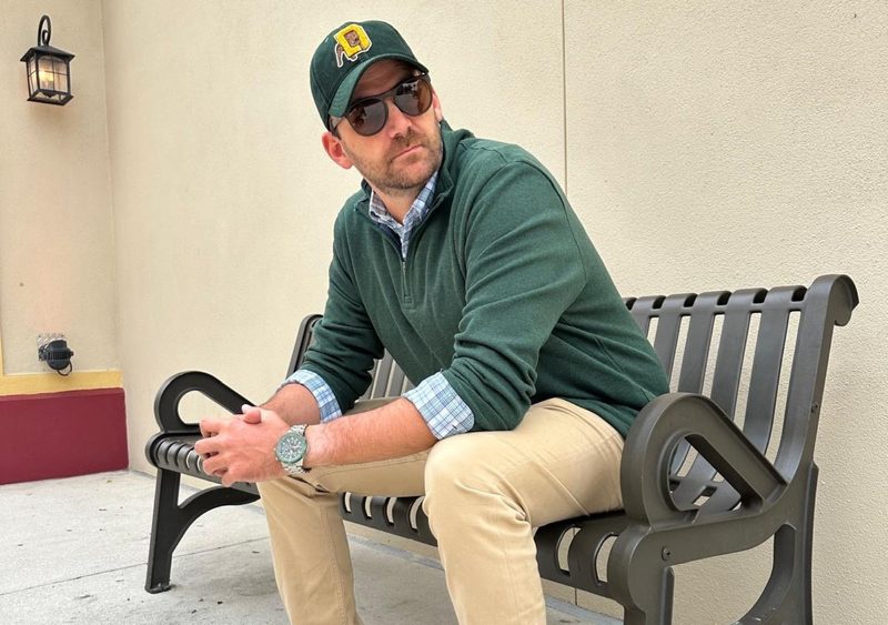 Man in green sweater and hat