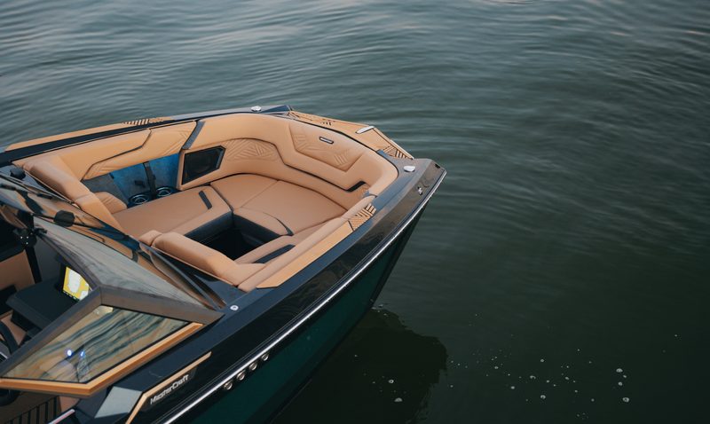 MasterCraft XStar X23 high performance wav and wakeboard boat on water bow seating area.
