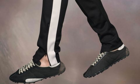 model wearing black retro running sneakers