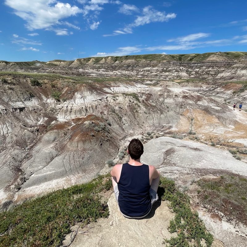 Sitting in Midland Provincial Park in the Alberta badlands