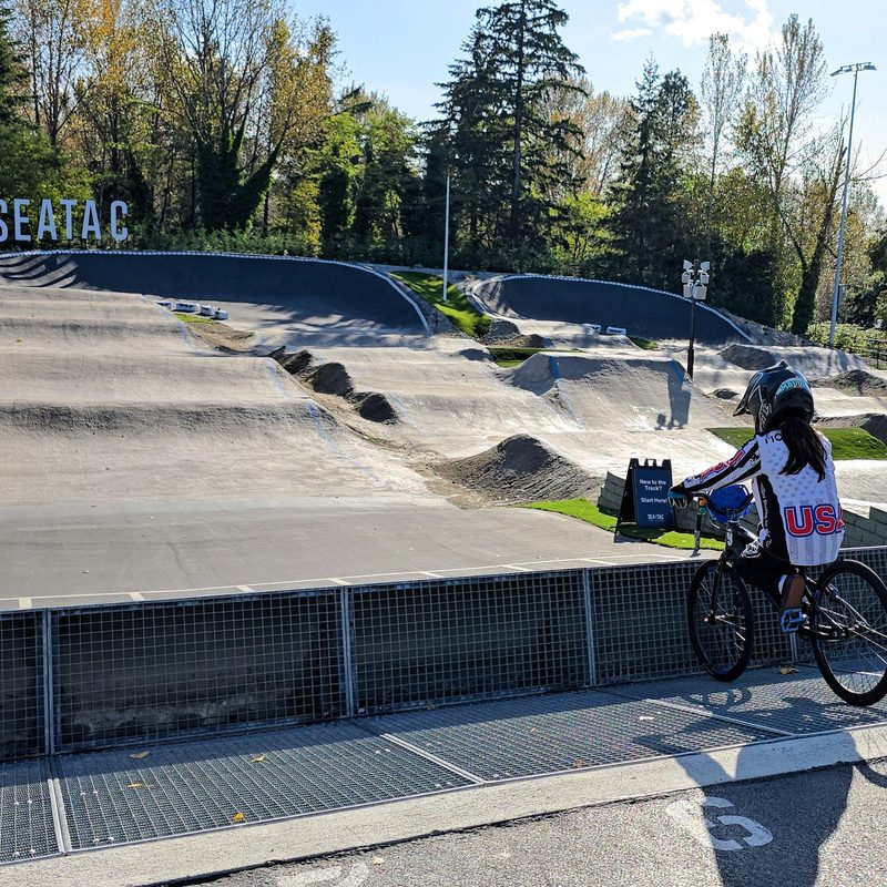 The BMX pump track with a young girl ready to ride her bike