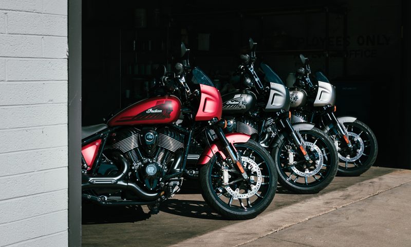 Three 2025 Indian Sport Chief motorcycles lined up in a garage.