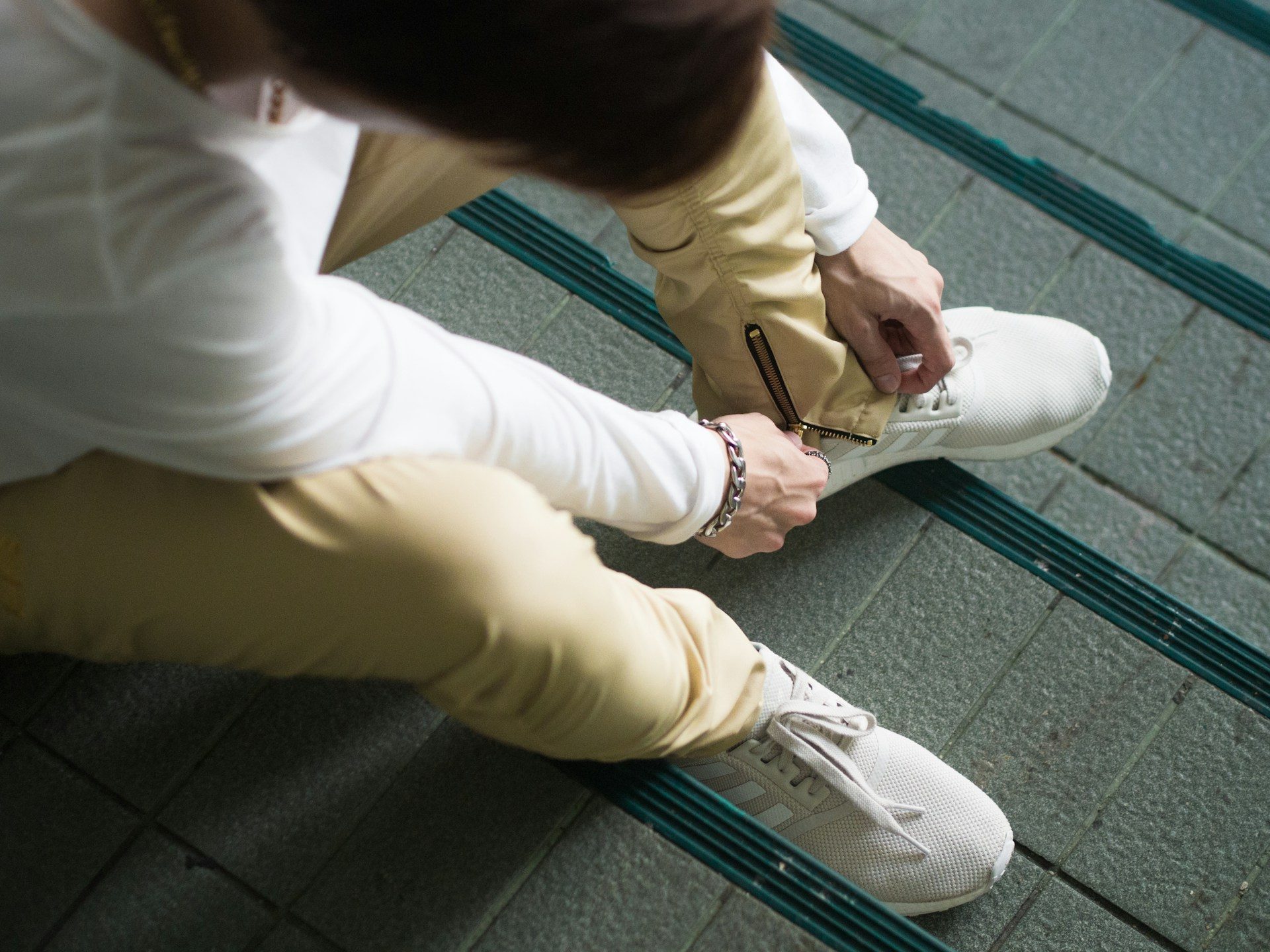 person sitting and putting on shoe
