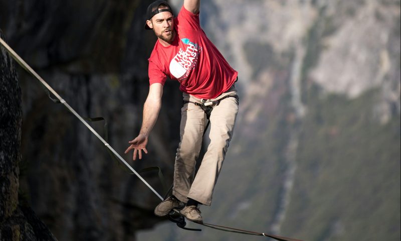 man walking tightrope