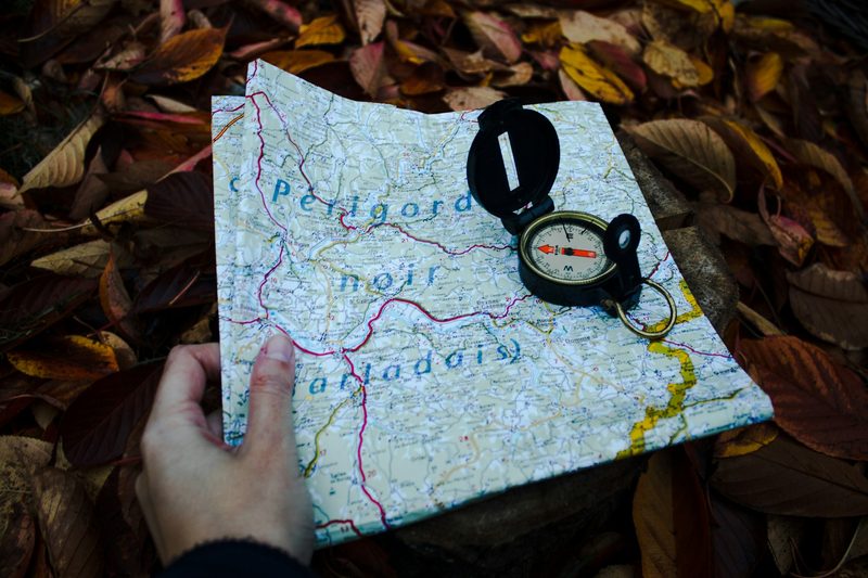 A compass on top of a folded map.