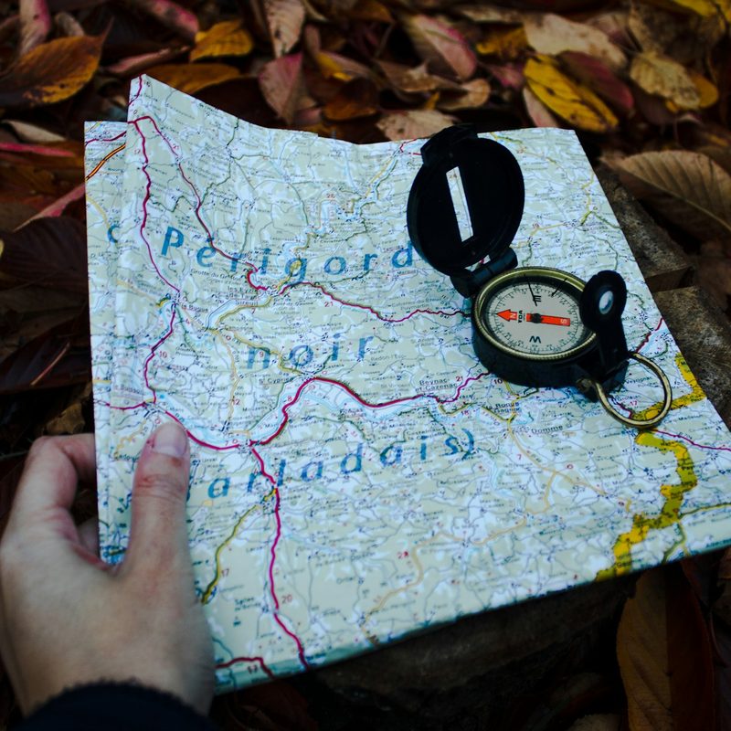 A compass on top of a folded map