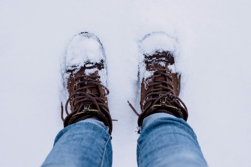 A pair of snowy hiking boots
