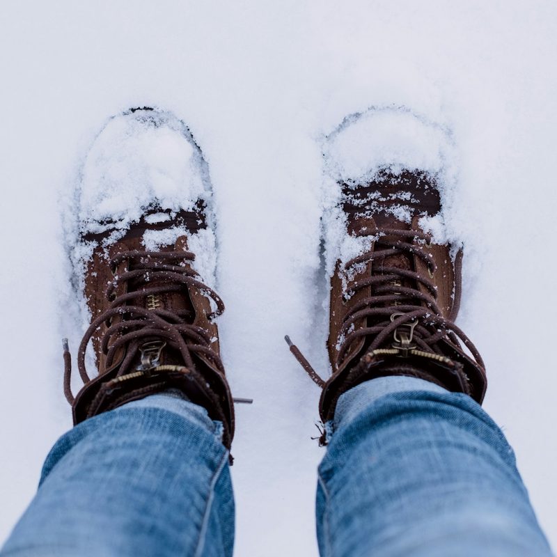 A pair of snowy hiking boots