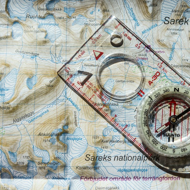 Baseplate compass on top of a map