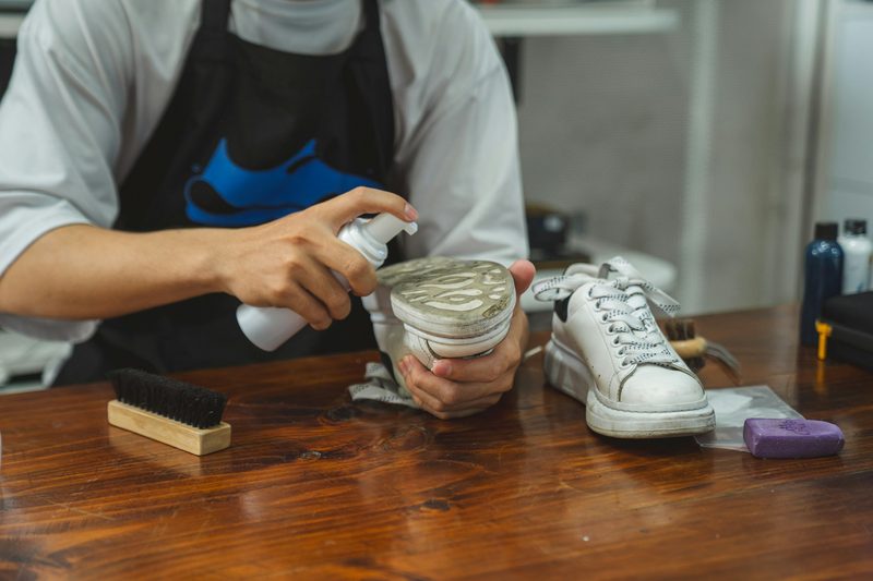 person cleaning shoe sole