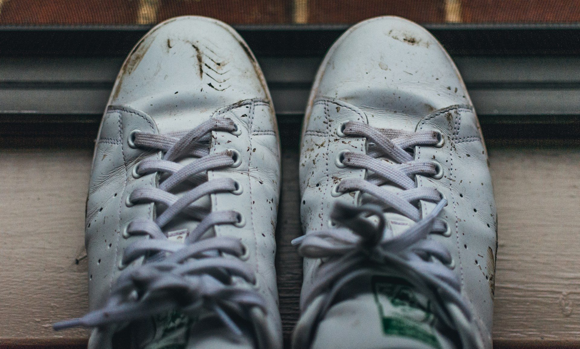 closeup on dirty white leather sneakers