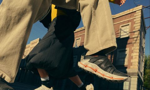 models wearing black and white sneakers on street